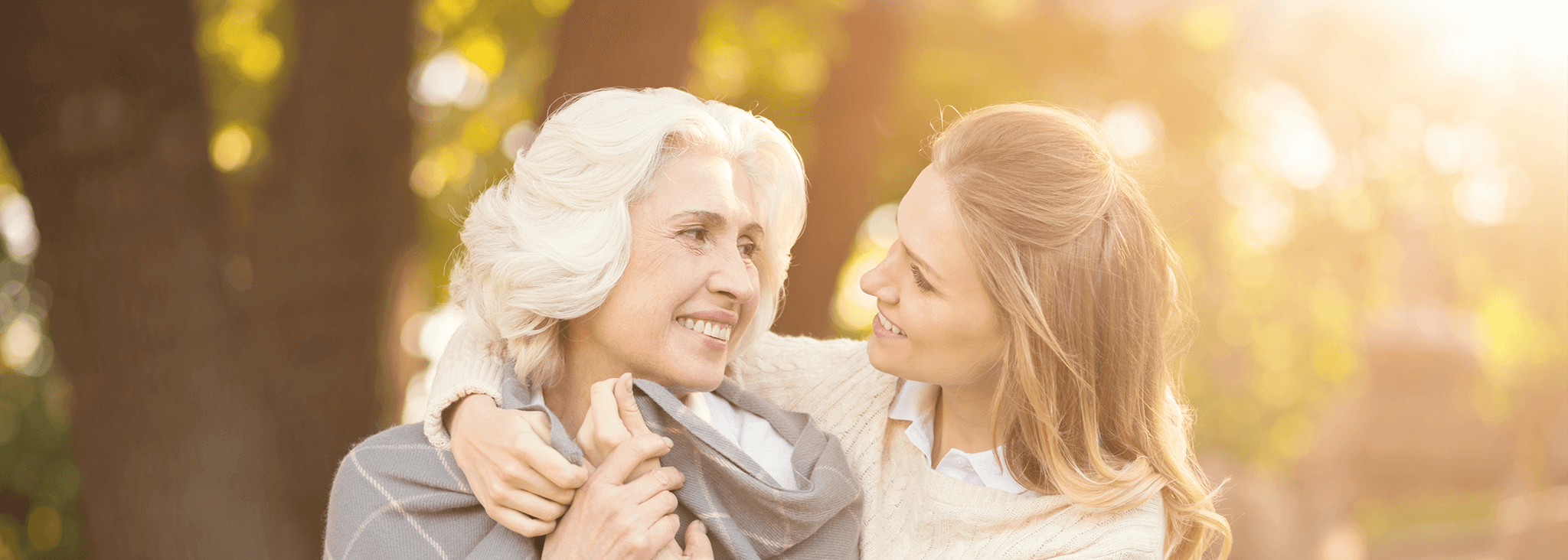 Planning for later life and long term care - Mother and daughter outside looking at each other