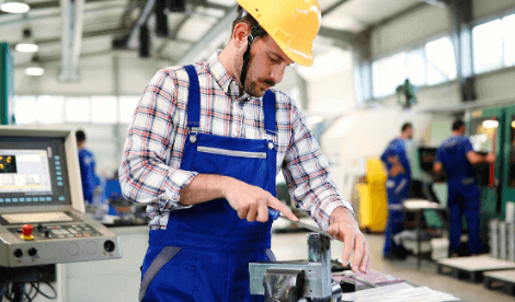 Manufacturing worker hand finishing metal work in industrial environment