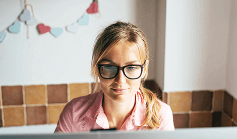 A woman working from home in front of computer
