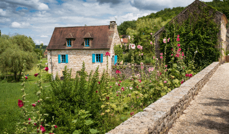 A beautiful European holiday home in the sun with flowers surrounding the property