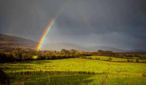 Rainbow over open ground