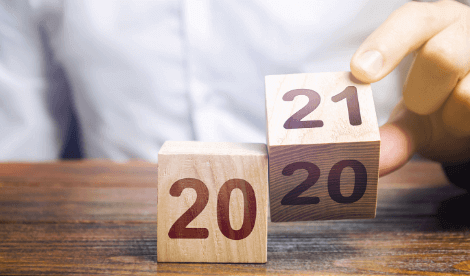 Painted wooden blocks being turned over to say 2021