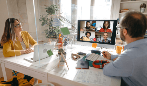 Individuals looking at computer screen