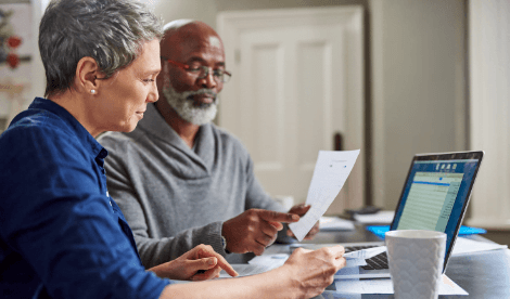 Old couple looking at paper