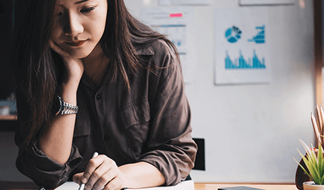 Business woman using calculator for do math finance on wooden desk in office