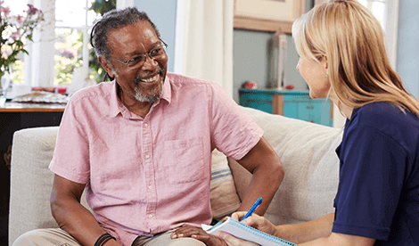 Female Support Worker Visits Senior Man At Home