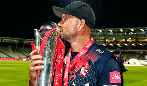 man kissing trophy