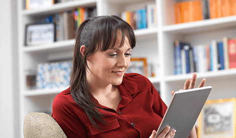 Woman consuming digital services on her tablet device