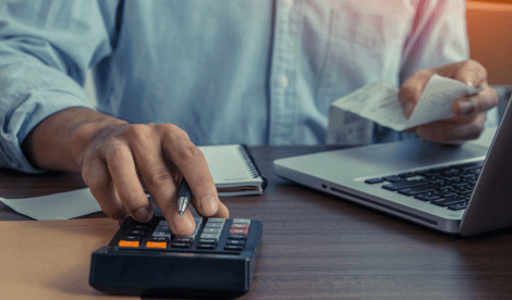 Close up photo of a hand inputting data into a calculator.